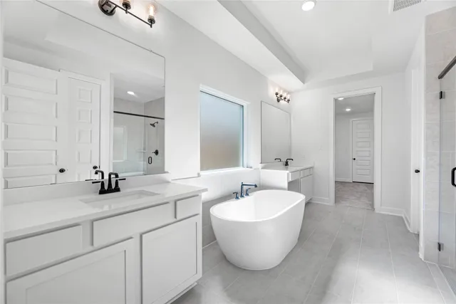 a bathroom with a double vanity sink and mirror