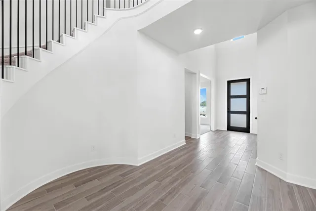 a view of an entryway with wooden floor