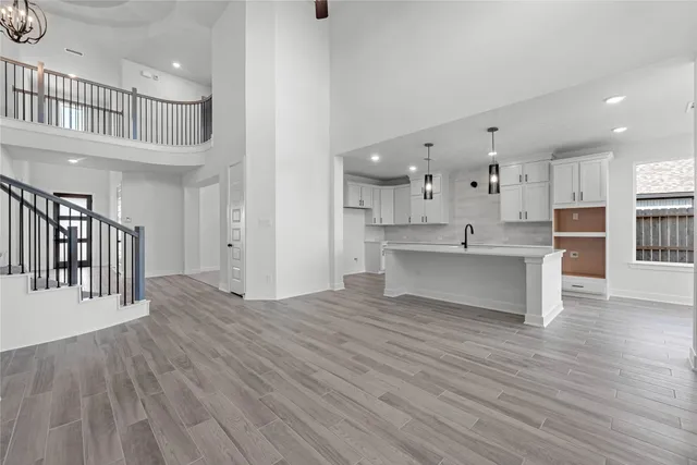 a view of a kitchen center island cabinets and wooden floor
