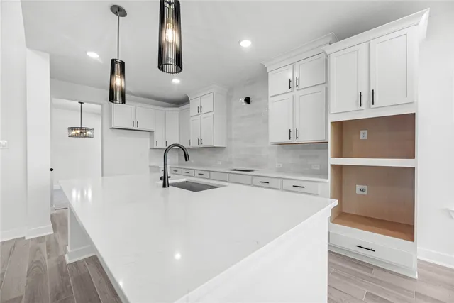 a kitchen with stainless steel appliances granite countertop a sink a stove and a refrigerator