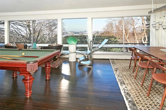 a dining room with wooden floor and a table