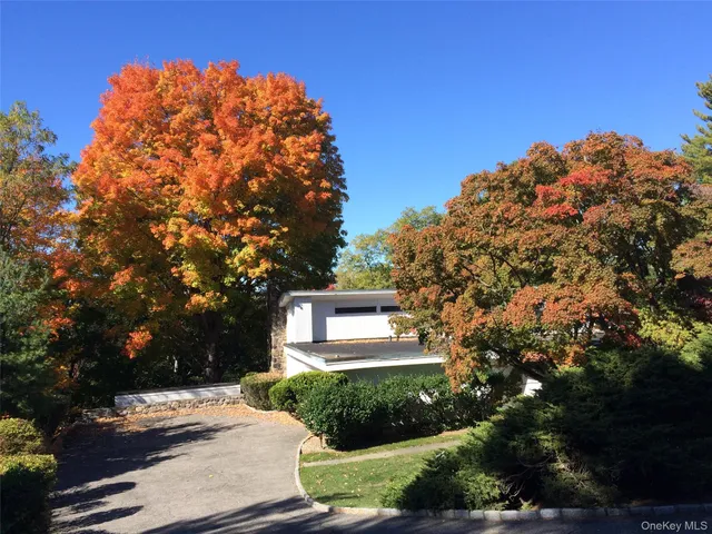 a view of a house with a yard and street view