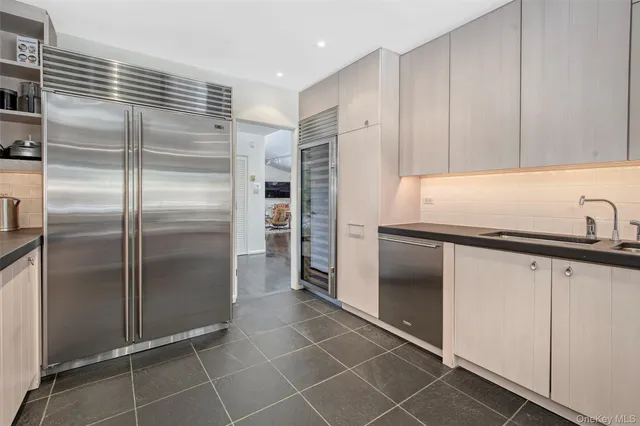 a kitchen with refrigerator and cabinets