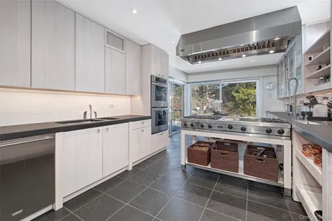 a dining room with furniture and a floor to ceiling window