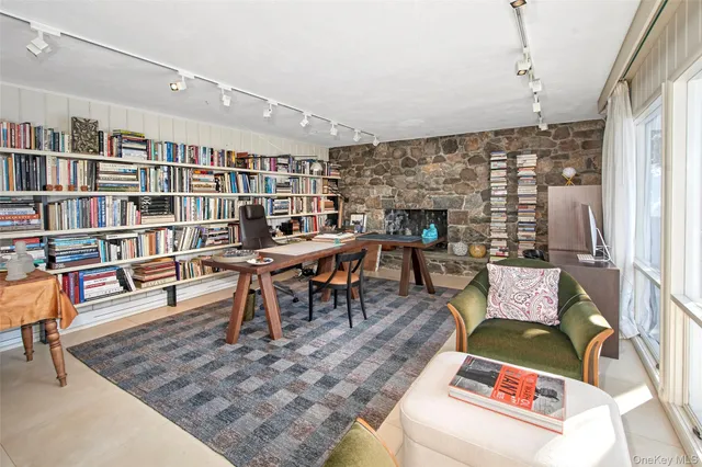 a living room with furniture and a book shelf
