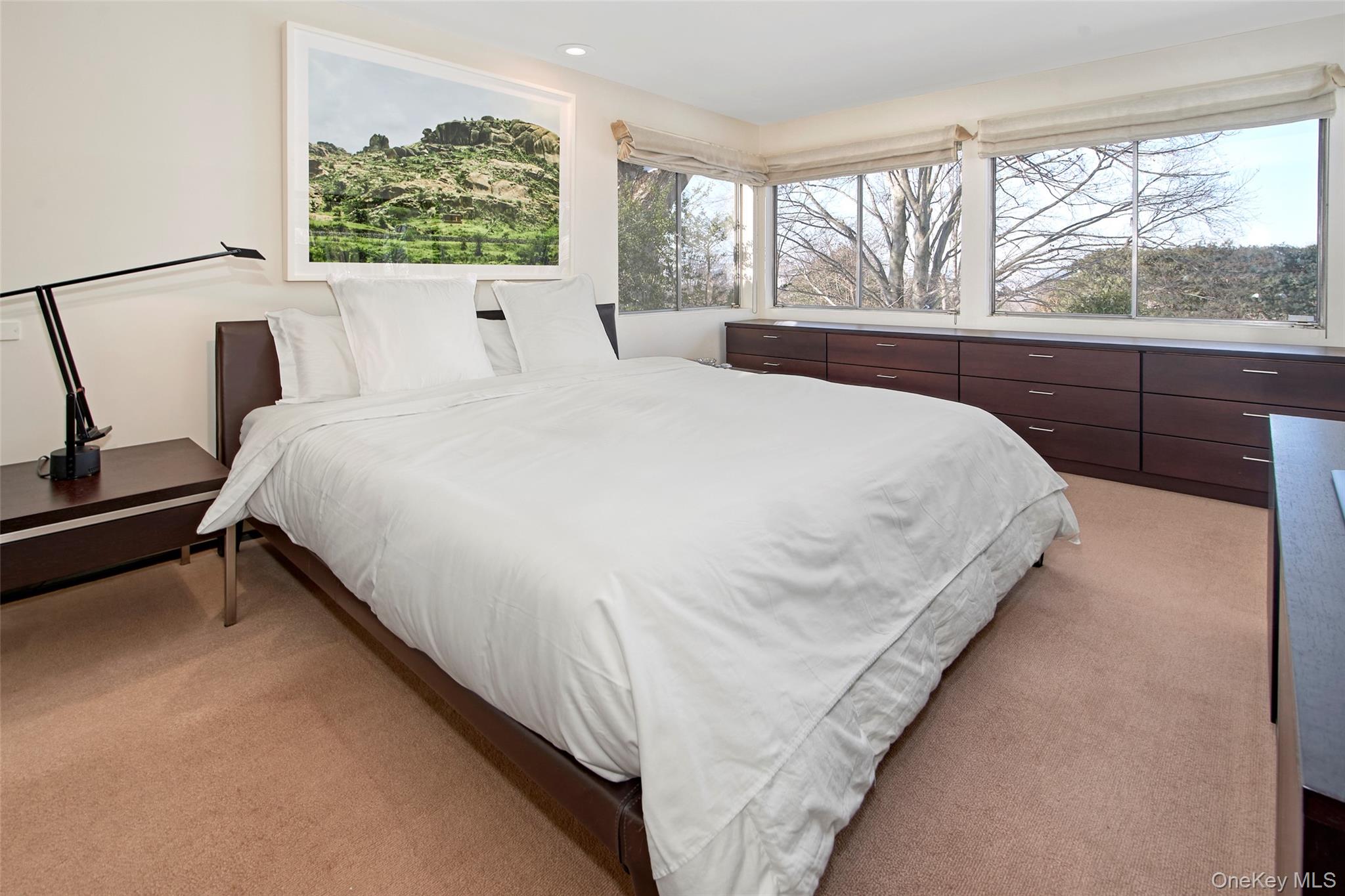 132 Ridgecrest Road Briarcliff Manor, NY 10510 - Photo 33 of 50 a large bed sitting in a bedroom next to a window