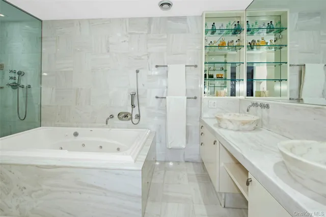 a bathroom with a tub sink and mirror