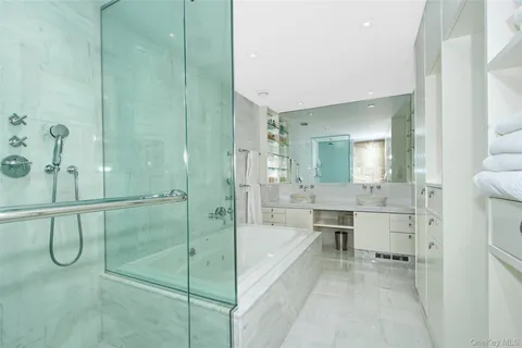 a bathroom with a tub sink and mirror