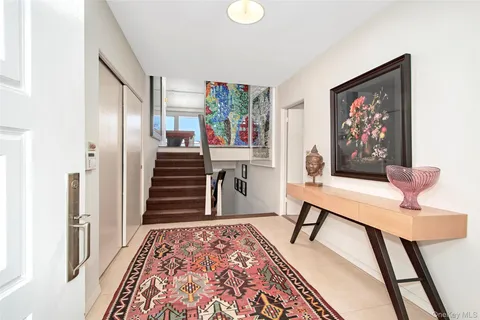 a view of a hallway with furniture and stairs