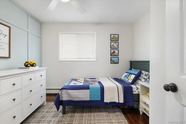a bedroom with a bed and a dresser in it