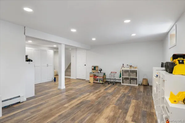 a view of a room with wooden floor and furniture