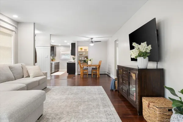 a living room with furniture a fireplace and a flat screen tv