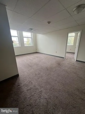 a view of an empty room with windows