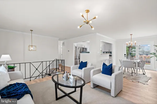 a living room with furniture and a dining table