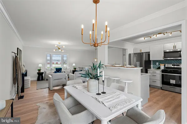 a living room with stainless steel appliances kitchen island granite countertop furniture and a dining table