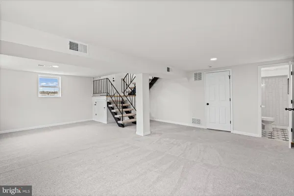 a view of an empty room with windows