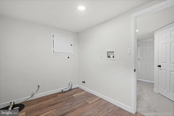 a view of a room with wooden floor