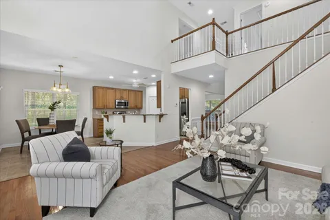 a living room with furniture or dining table and a chandelier