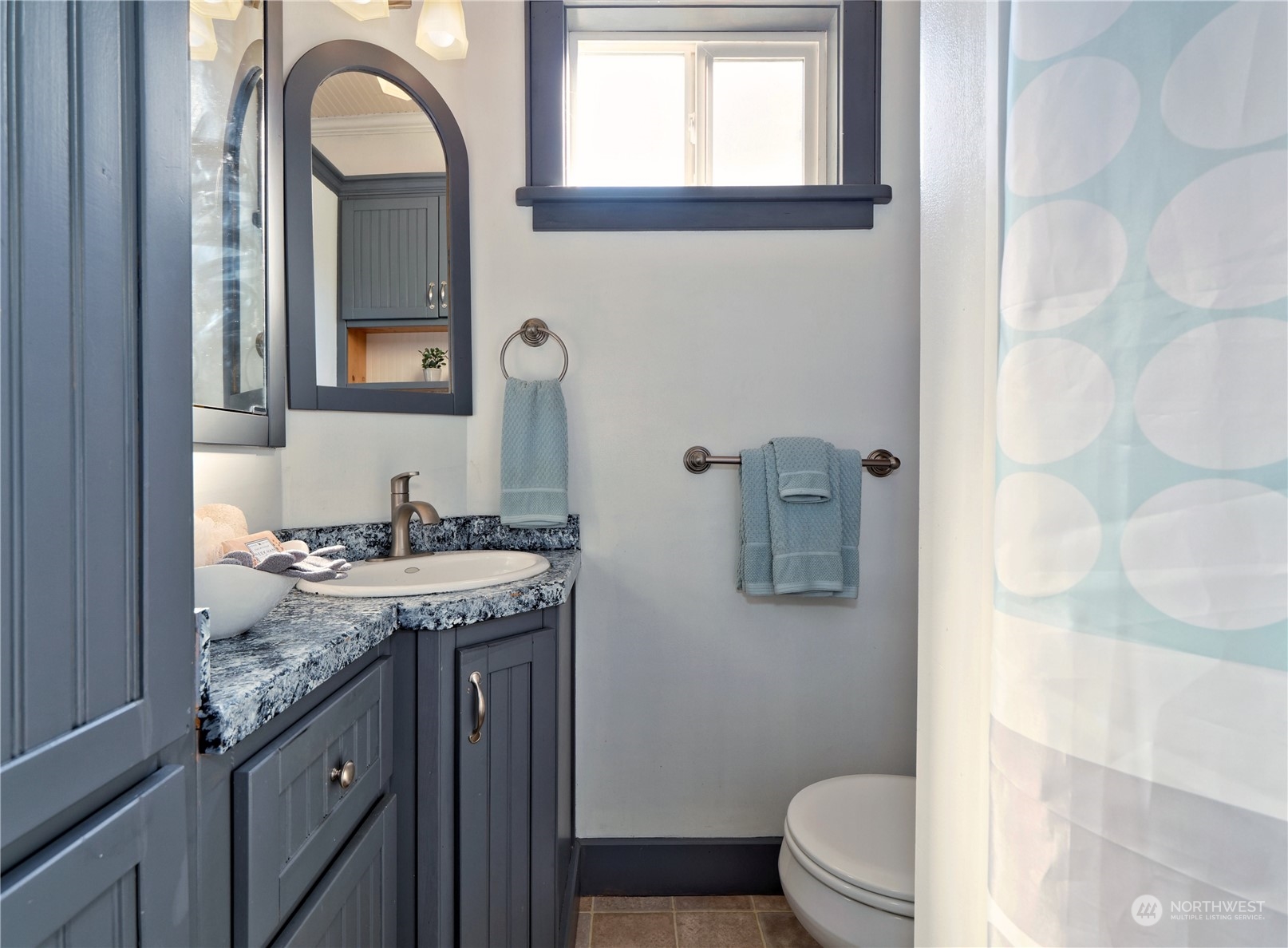 515 Wells Avenue South Renton, WA 98057 - Photo 16 of 25 a bathroom with a granite countertop toilet sink and mirror