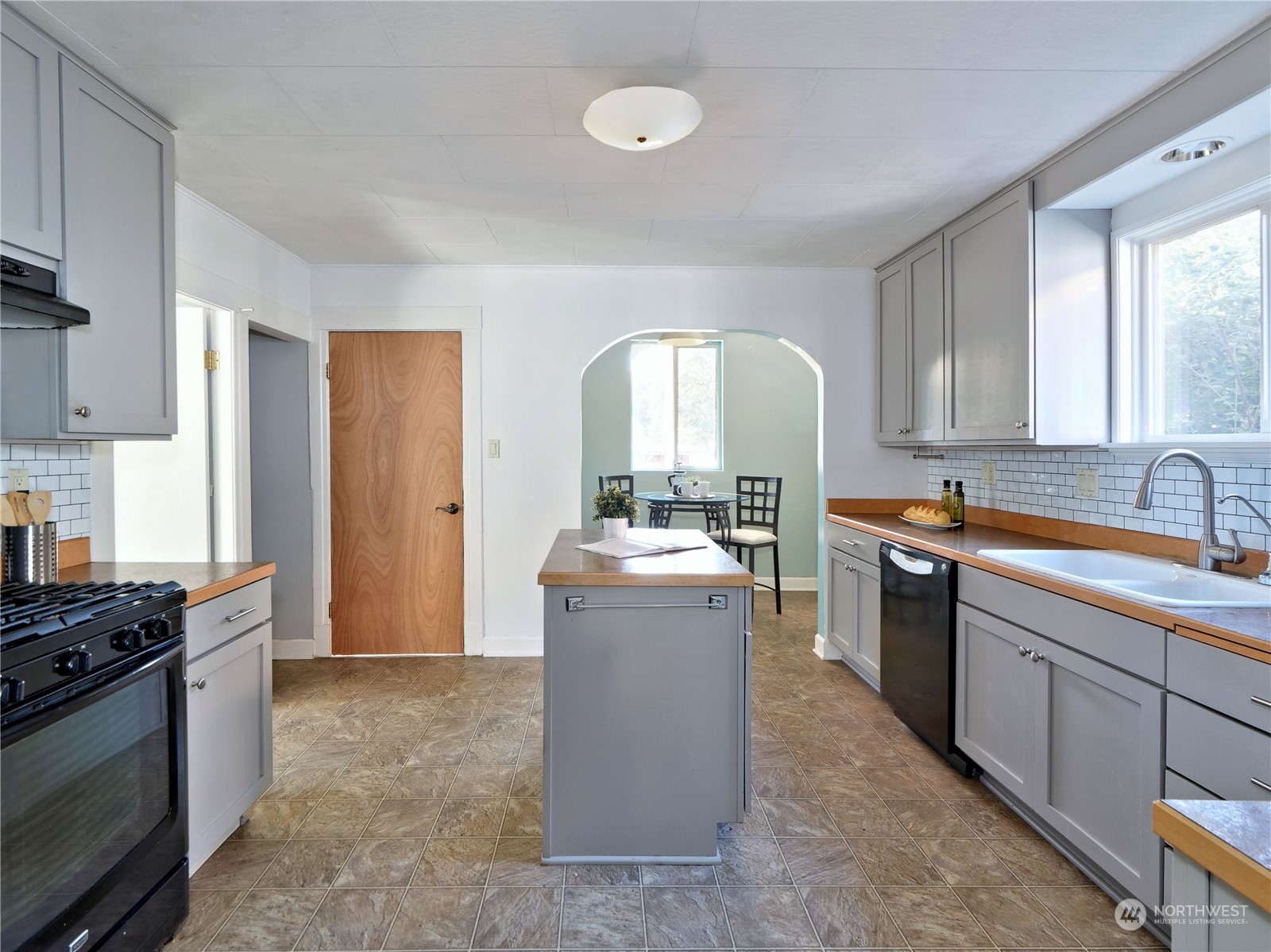 515 Wells Avenue South Renton, WA 98057 - Photo 7 of 25 a kitchen with a sink stove and cabinets