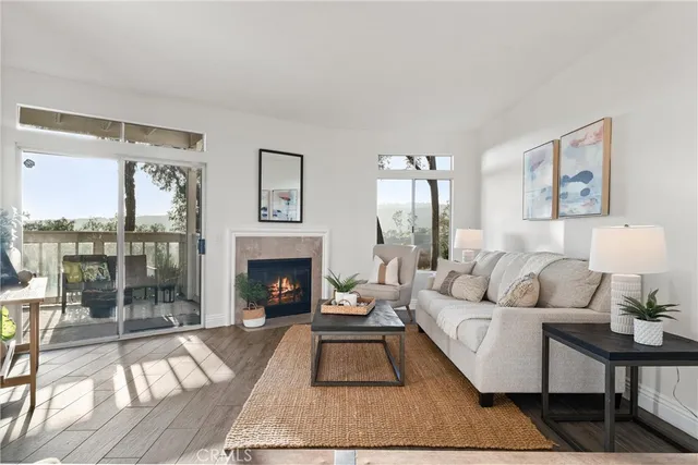 a living room with furniture a large window and a fireplace