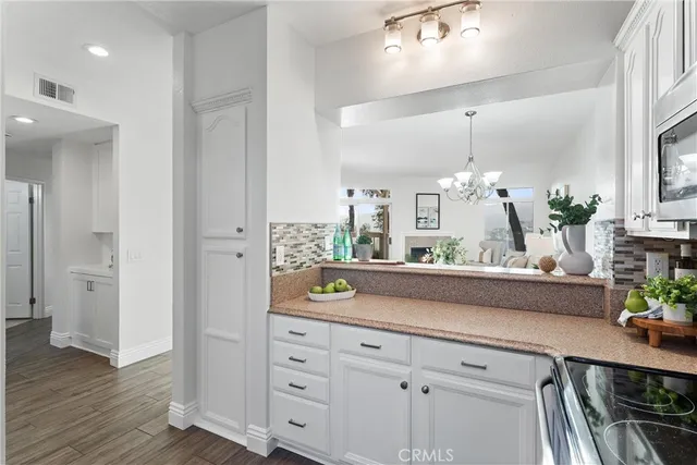 a bedroom with a bed chandelier and a window