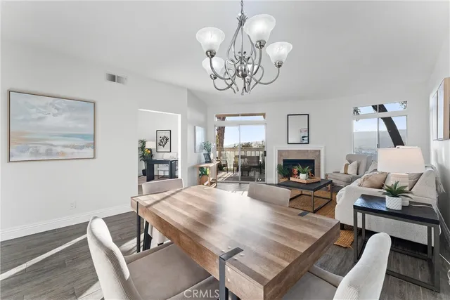 a living room with furniture a fireplace and a chandelier