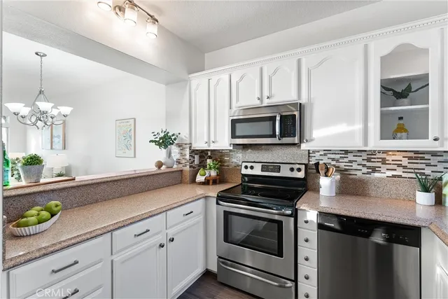 a kitchen with a sink stove and microwave