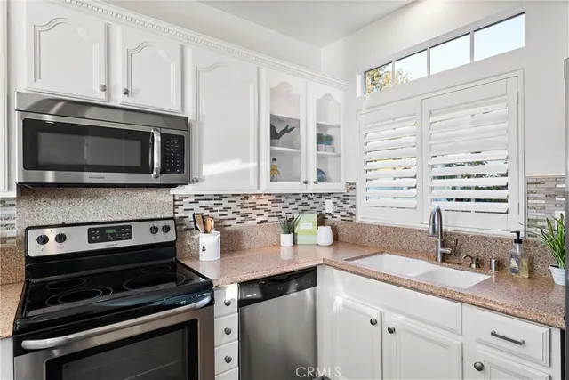 a kitchen with a refrigerator stove and sink