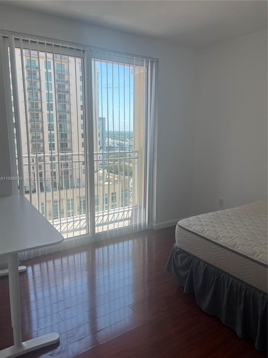 7350 Southwest 89th Street, Unit 1801S Miami, FL 33156 - Photo 13 of 15 a bed sitting in a bedroom next to a window