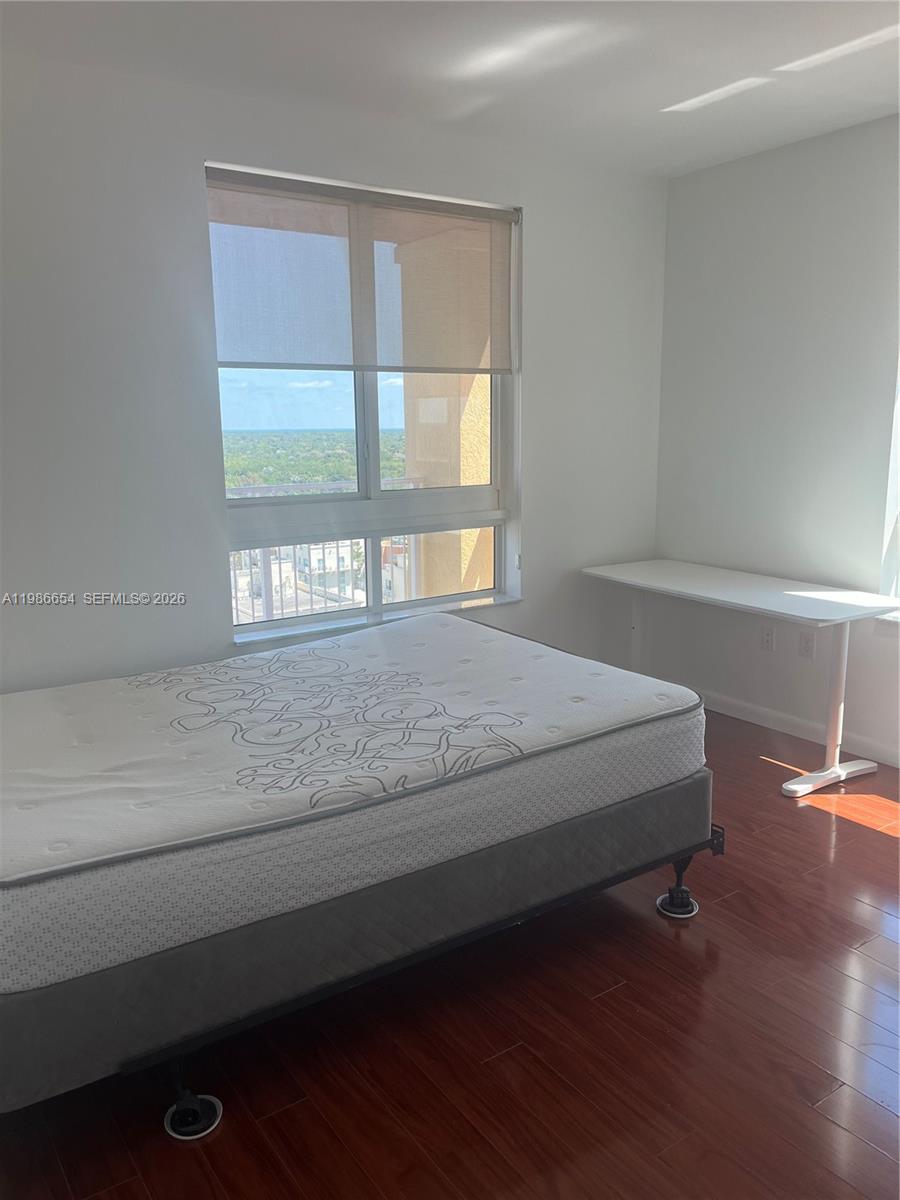 7350 Southwest 89th Street, Unit 1801S Miami, FL 33156 - Photo 15 of 15 a bedroom with a bed and window