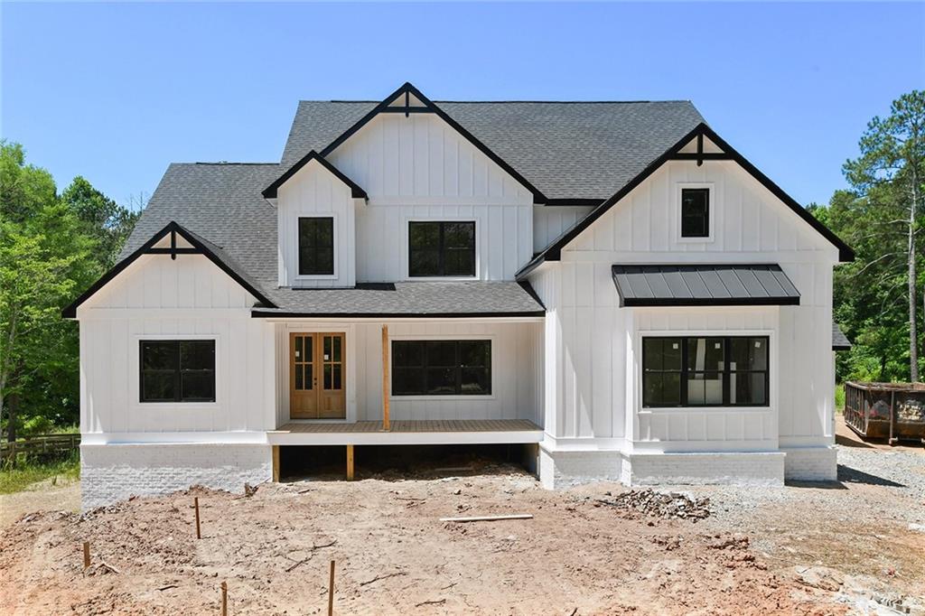 14220 Cogburn Road Milton, GA 30004 - Photo 1 of 1 a front view of a house with a yard and garage