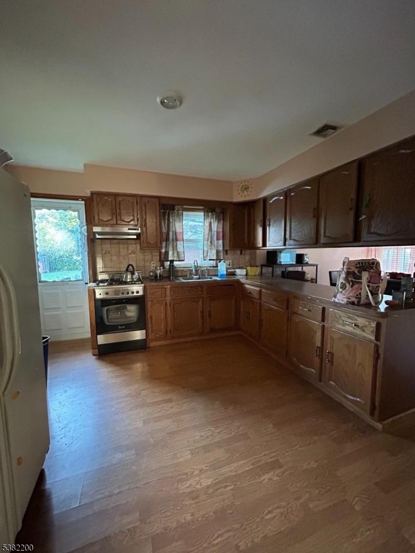 328 West Inman Avenue Rahway, NJ 07065 - Photo 5 of 9 a kitchen with stainless steel appliances granite countertop a stove sink and cabinets