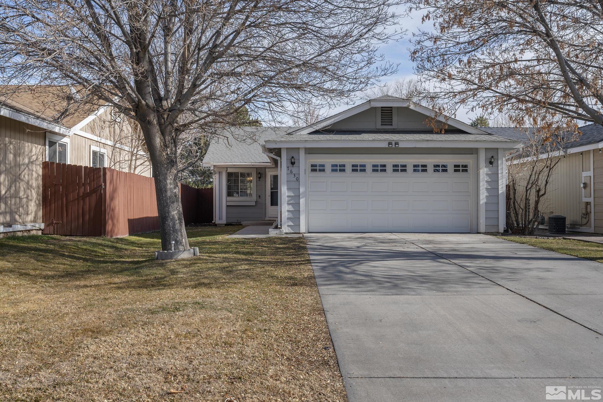 7630 Water View Way Reno, NV 89511 - Photo 1 of 25 a front view of a house with a yard and garage