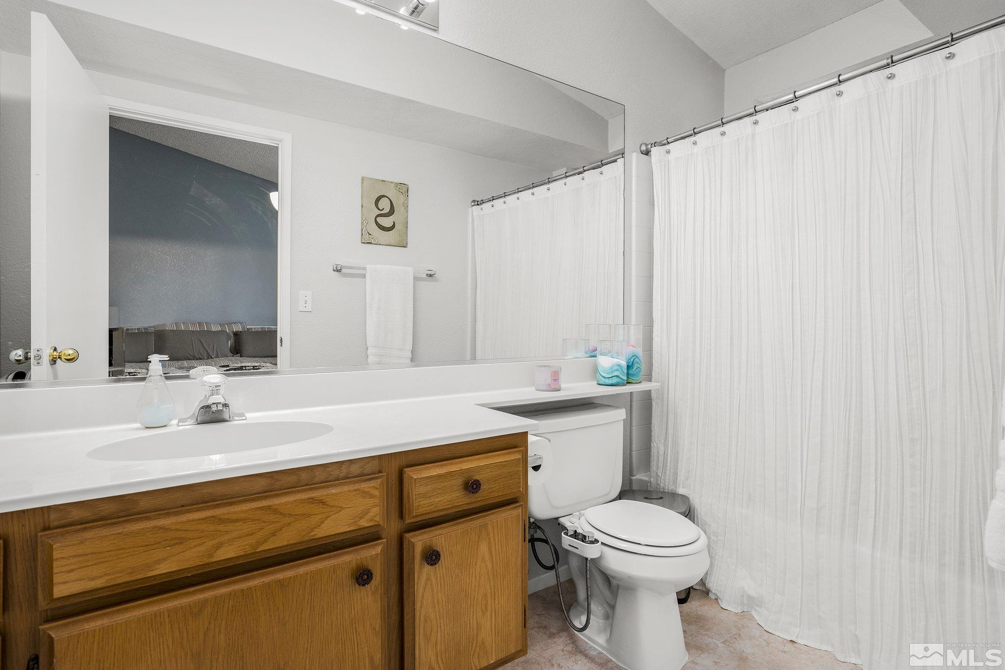 7630 Water View Way Reno, NV 89511 - Photo 15 of 25 a bathroom with a sink a toilet and a mirror