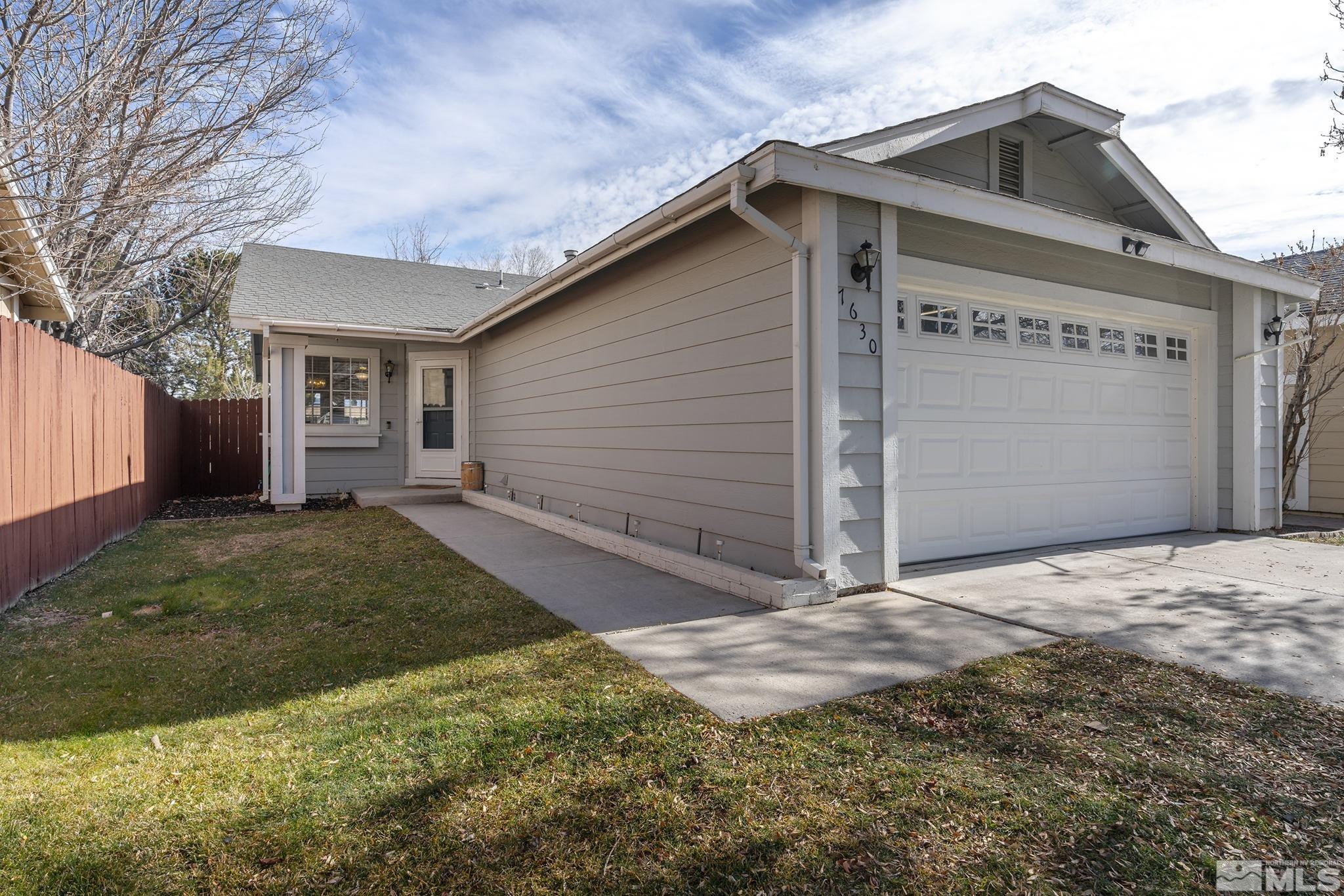 7630 Water View Way Reno, NV 89511 - Photo 3 of 25 a front view of a house with a yard and garage