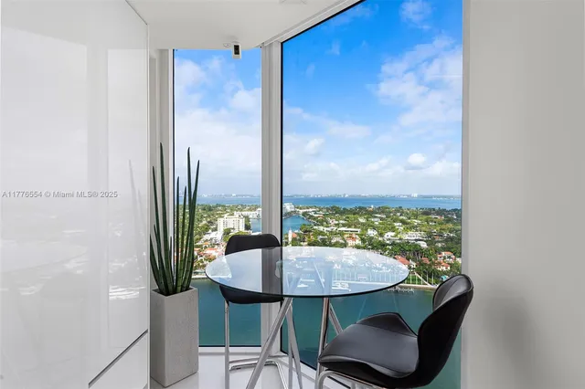 a view of a room with a table and chairs