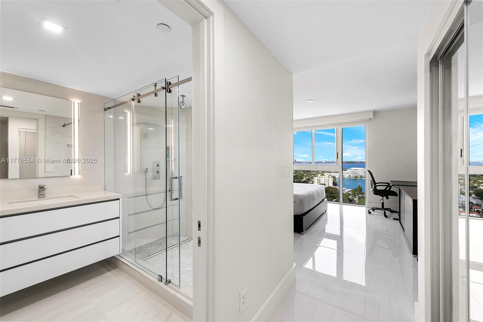 4775 Collins Avenue, Unit 2607 Miami Beach, FL 33140 - Photo 13 of 48 a en suite bathroom with a tub shower and bedroom