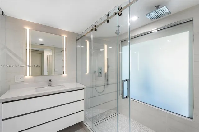 a bathroom with a shower sink and mirror