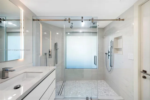 a bathroom with a tub sink shower and mirror