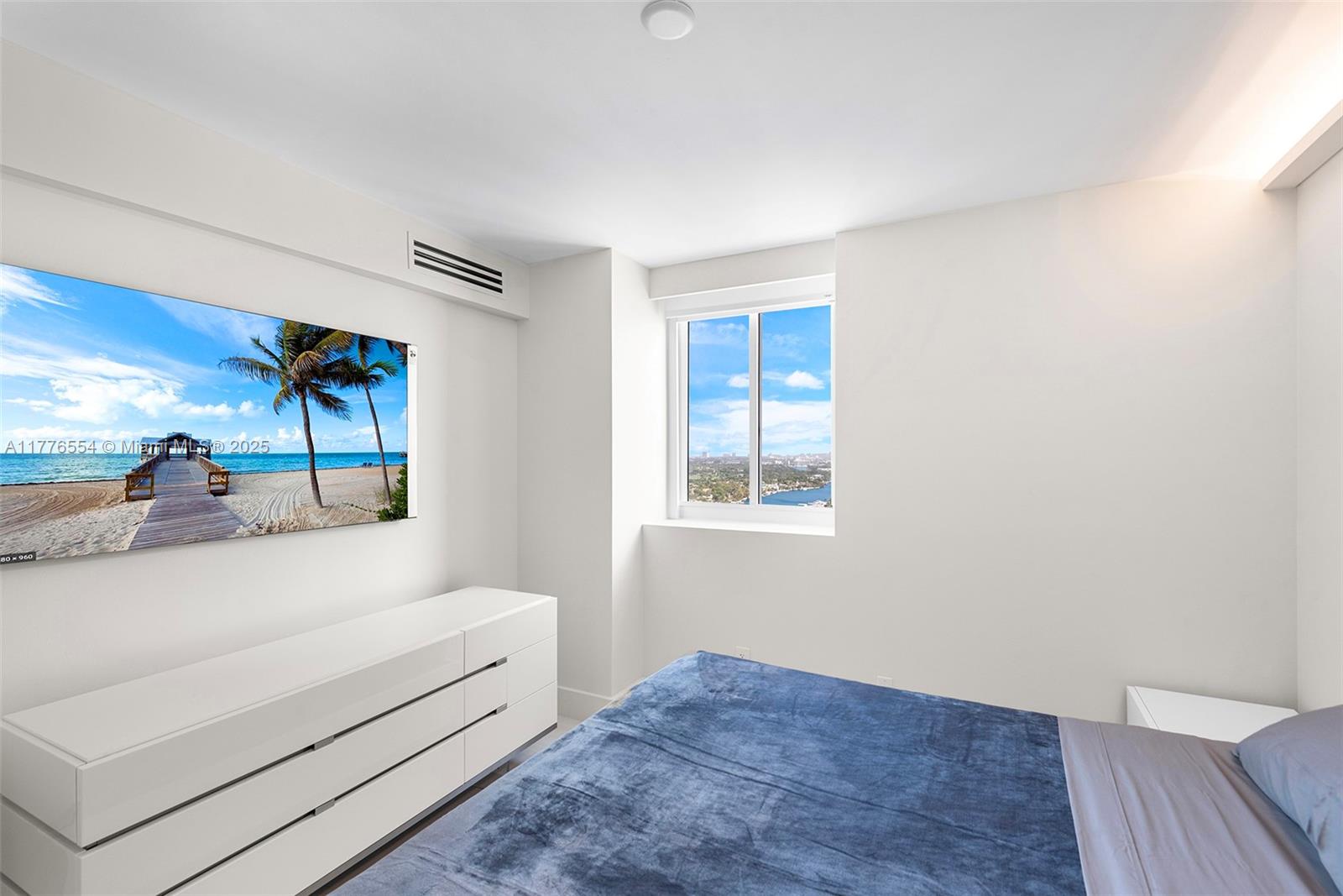 4775 Collins Avenue, Unit 2607 Miami Beach, FL 33140 - Photo 18 of 48 a view of a bedroom with cabinet and mirror