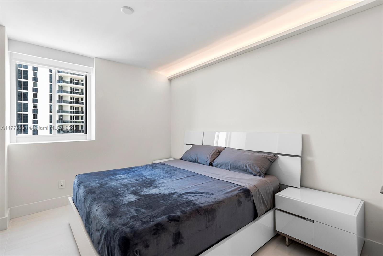 4775 Collins Avenue, Unit 2607 Miami Beach, FL 33140 - Photo 21 of 48 a bedroom with a bed and a window