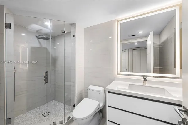 a bathroom with a sink toilet a mirror and shower