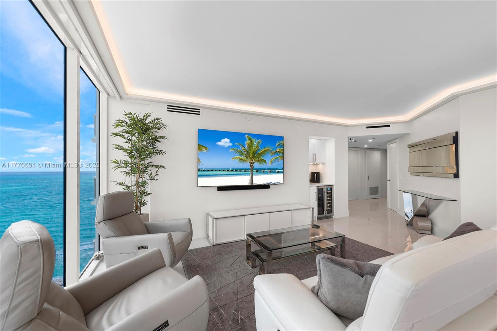 4775 Collins Avenue, Unit 2607 Miami Beach, FL 33140 - Photo 3 of 48 a living room with furniture and a flat screen tv