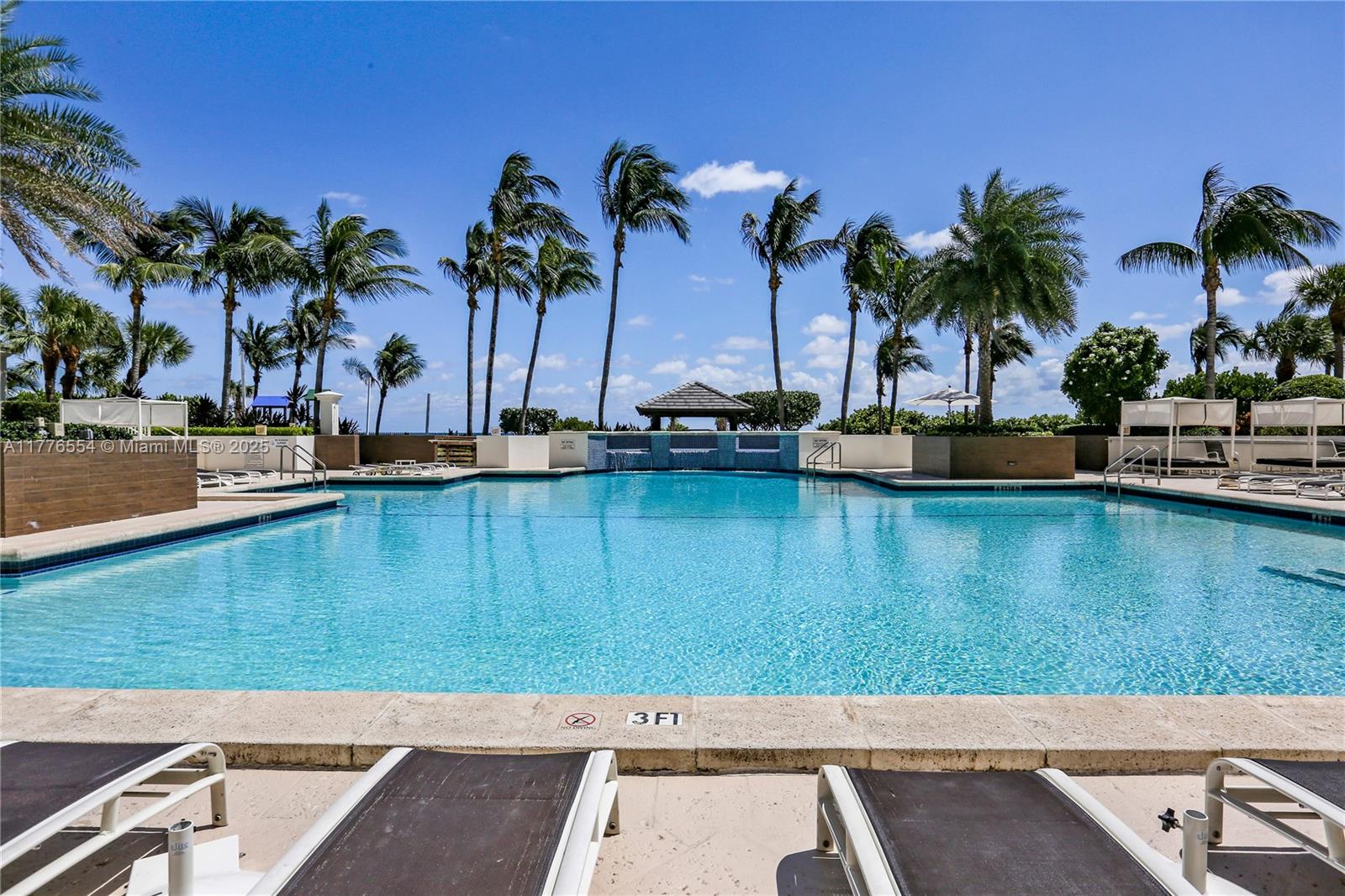 4775 Collins Avenue, Unit 2607 Miami Beach, FL 33140 - Photo 34 of 48 a view of a lake with a palm tree