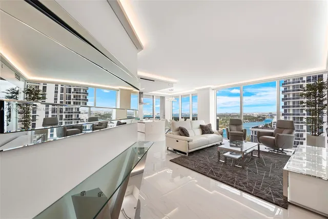 a large living room with furniture and a large window