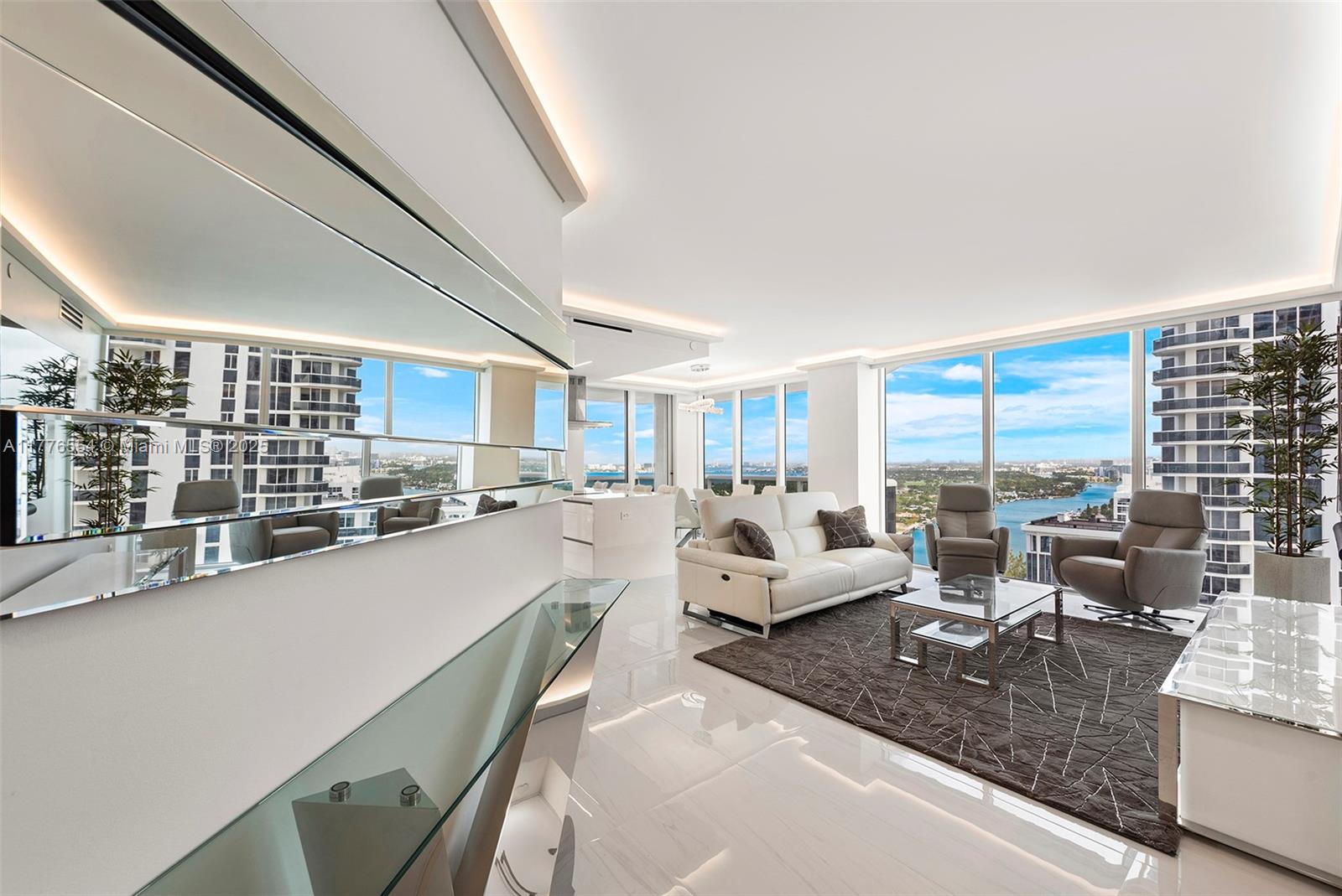 4775 Collins Avenue, Unit 2607 Miami Beach, FL 33140 - Photo 5 of 48 a large living room with furniture and a large window