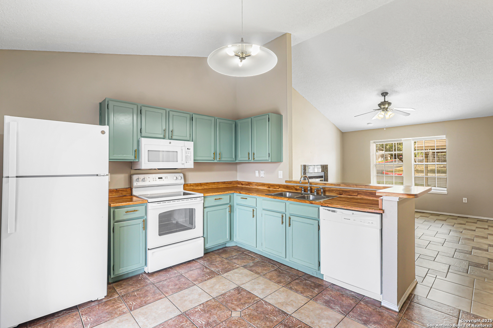 10254 Dover Ridge, Unit 806 San Antonio, TX 78250 - Photo 2 of 13 a kitchen with a sink refrigerator and cabinets