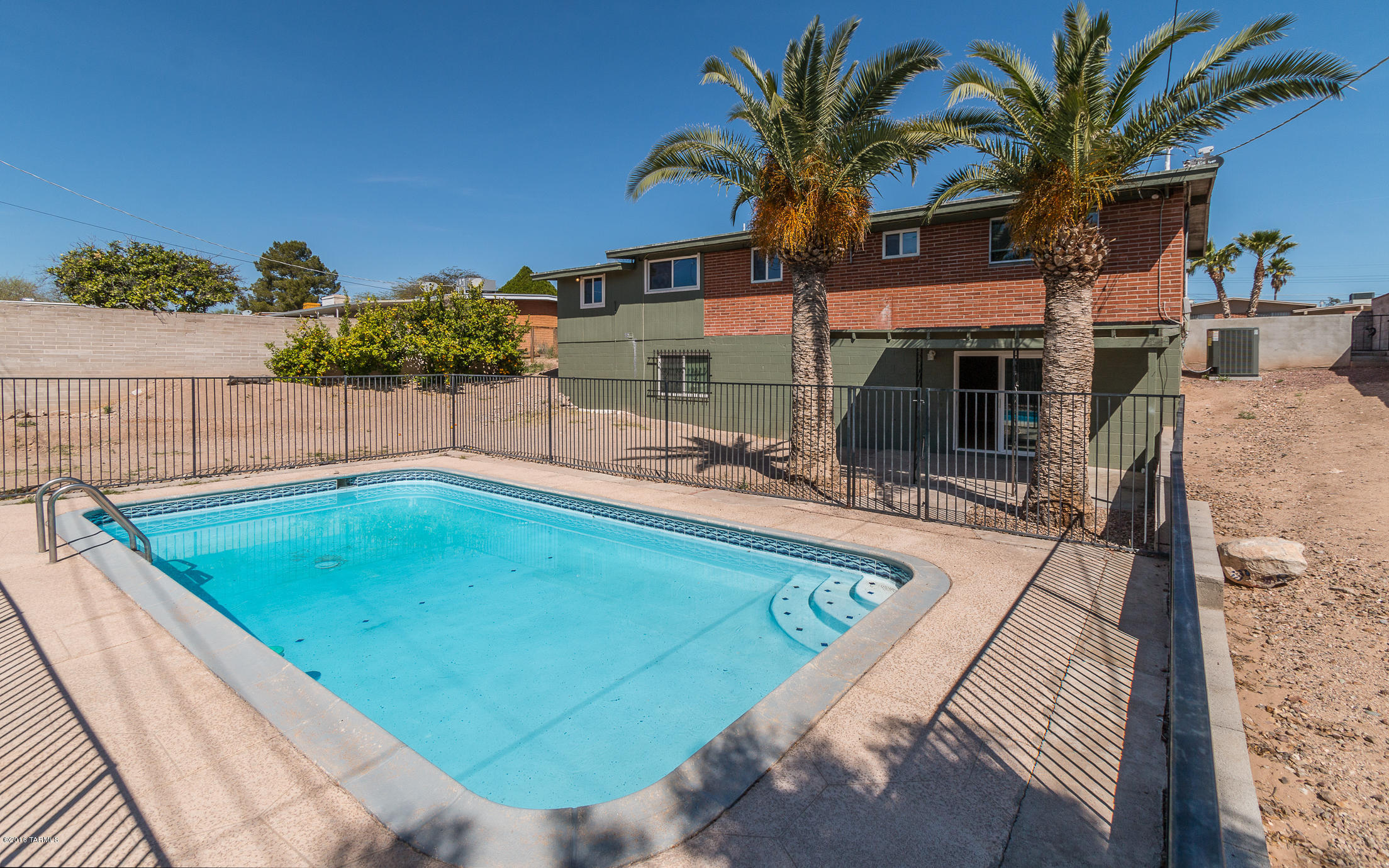 a swimming pool with outdoor seating and yard