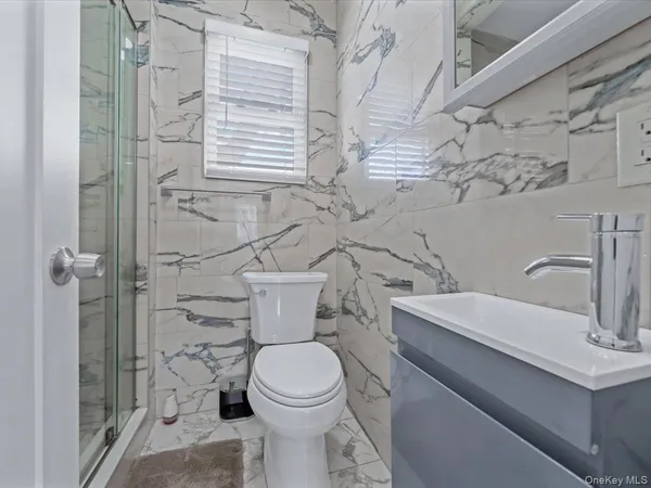 a bathroom with a toilet sink and shower